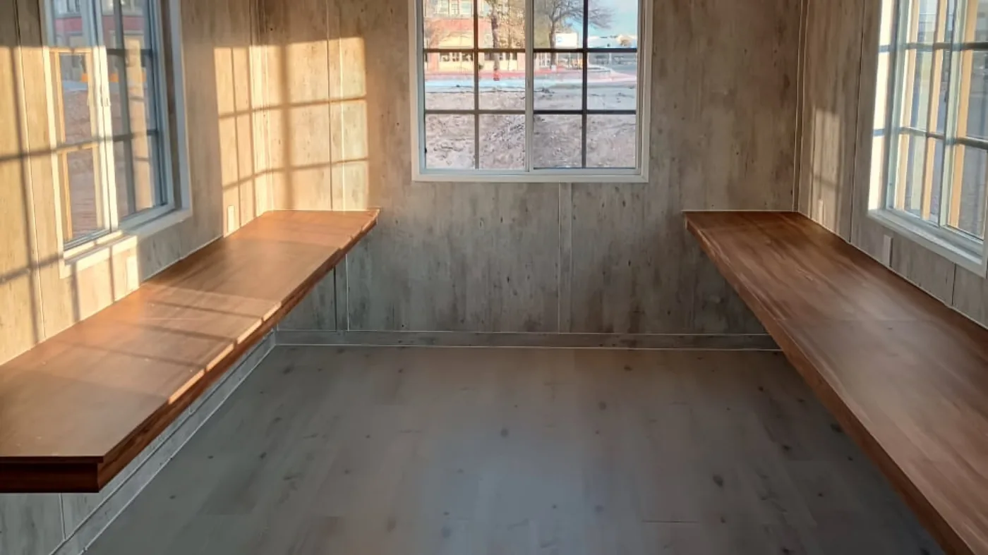 Hardwood work bars along both walls of a DBOX mobile office
